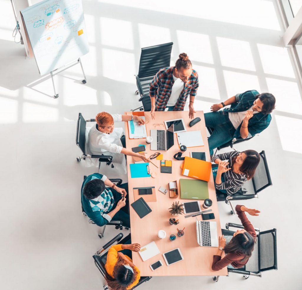 Team collaborating around a table, seen from above